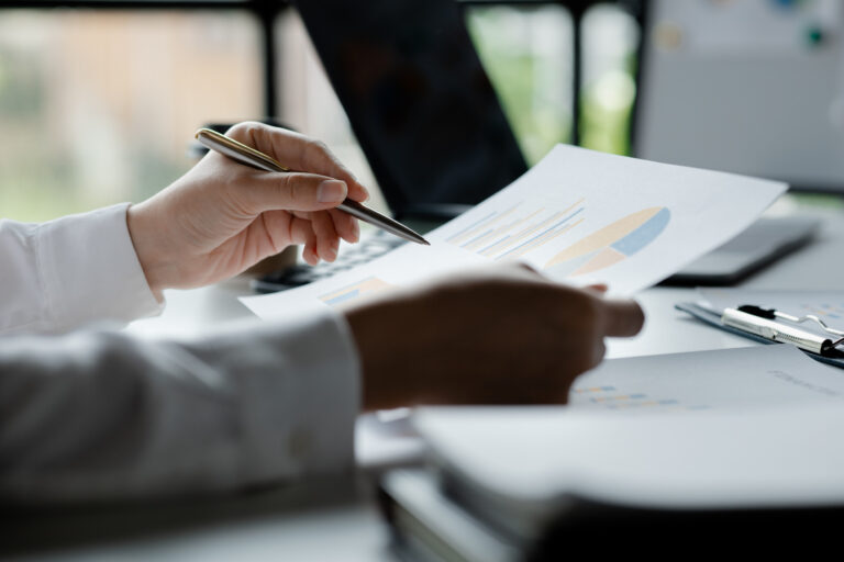 Business men are looking at the company's financial documents to